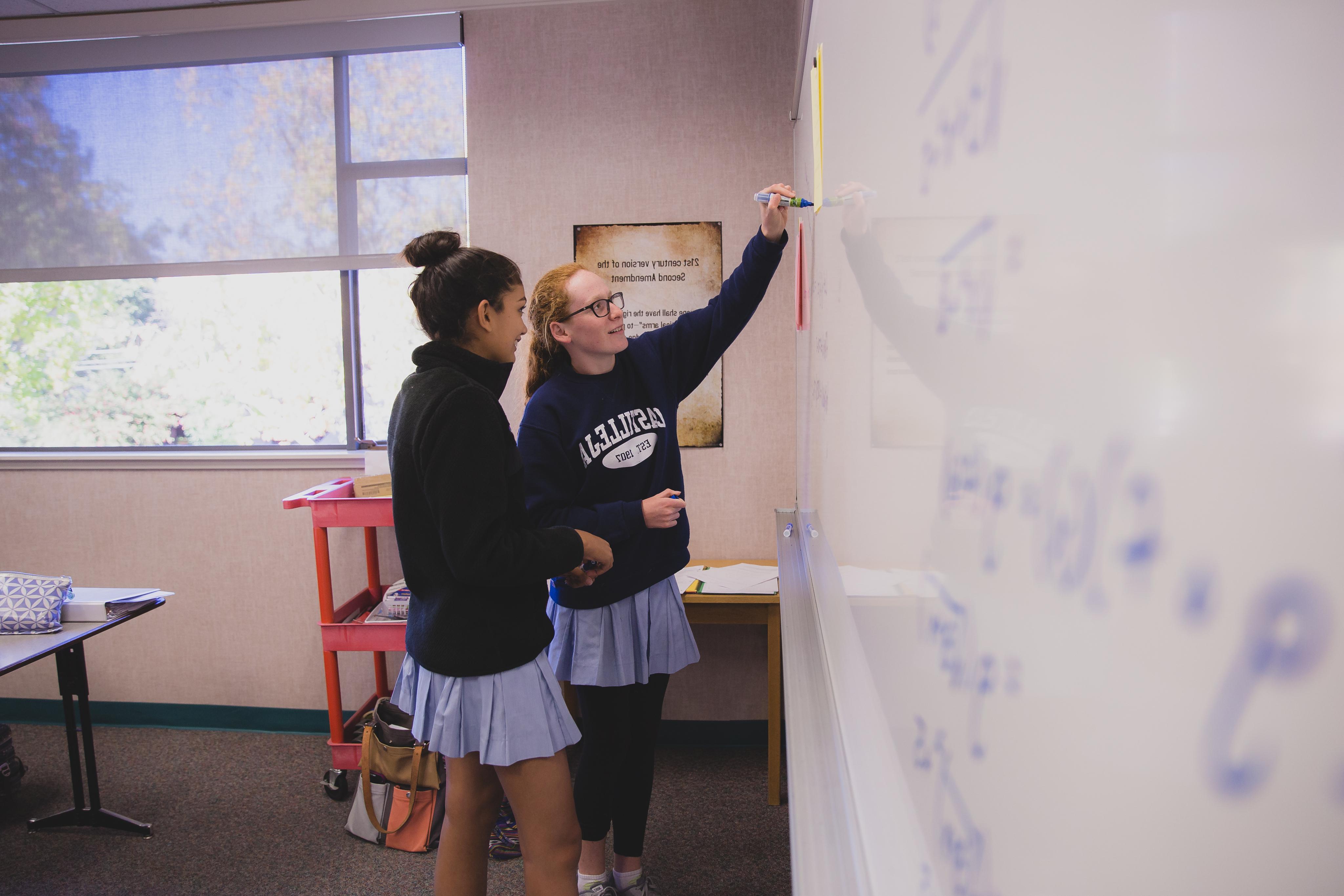 Math students work in pairs to figure out the best approach to algebraic problems